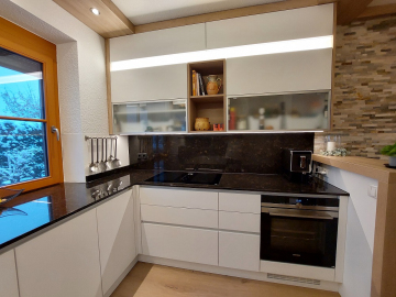 Moderne Küche, Fronten weiß Supermatt-Anti-Fingerprint, Granit Arbeitsplatte und Nischenrückwand, LED Unterbau-Arbeitsplatzbeleuchtung